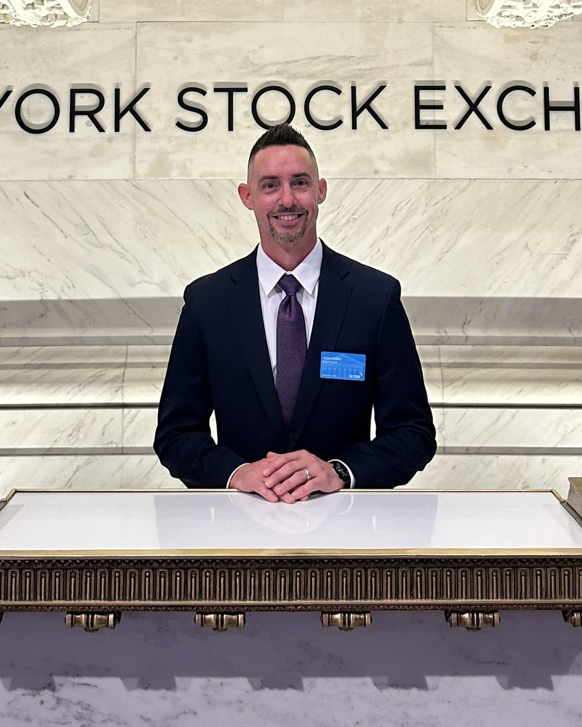 Sean Farro in a suit at the New York Stock Exchange.